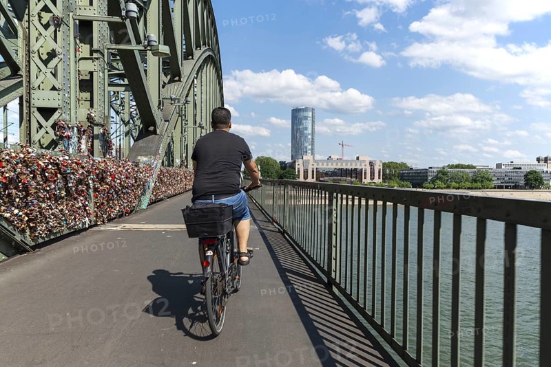 Cycling from a first-person perspective on a shared footpath and cycle path over the Hohenzollern Bridge in Cologne, North Rhine-Westphalia, Germany, Europe