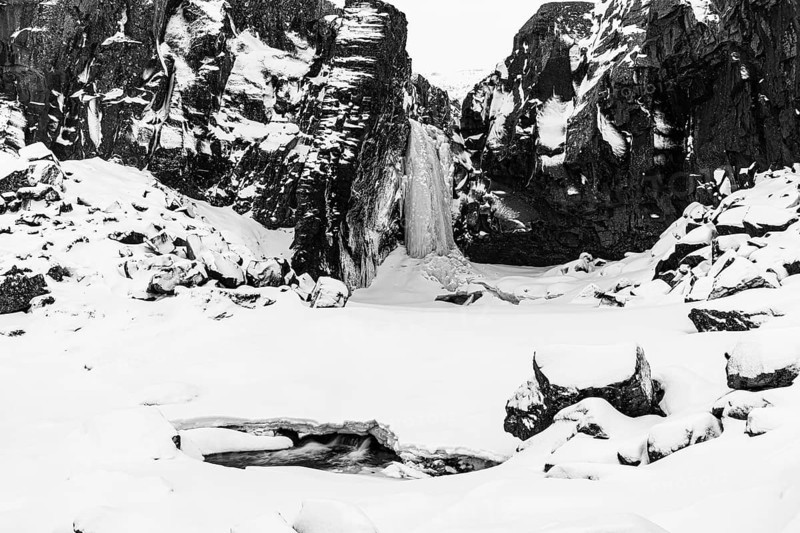 Frozen waterfall, Folaldafoss, snowy rock face and snowy landscape, black and white photo, Sudausturland, Iceland, Europe