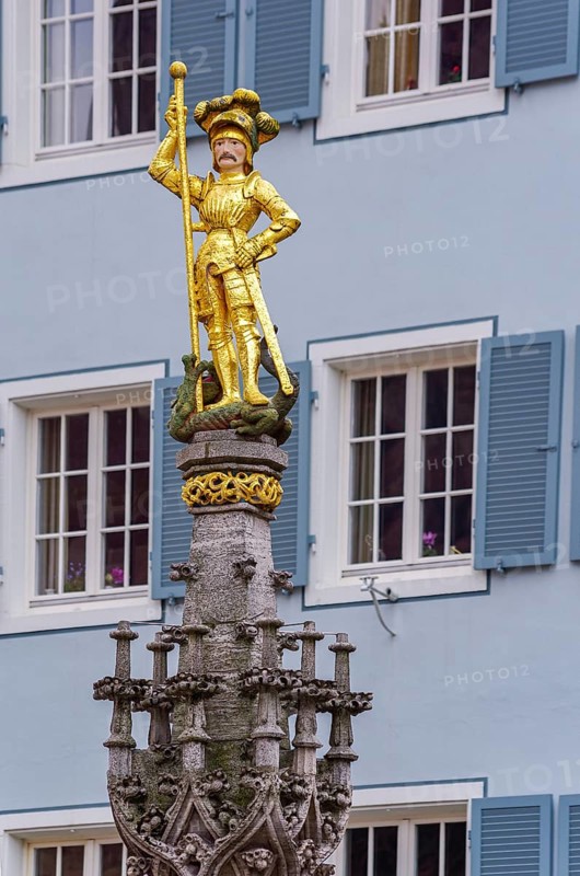 Statue of St. George standing on the defeated dragon, Georgsbrunnen on the Münsterplatz, Freiburg im Breisgau, Baden-Württemberg, Germany, Europe