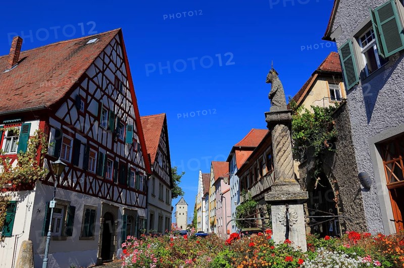 Typical Franconian village centre and the four-tube fountain in the village centre, Mainbernheim, Lower Franconia, Germany, Europe