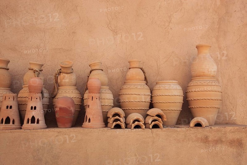 Clay jars in the courtyard of Nizwa Fort. Nizwa is the centre of the Omani heartland. The oasis town lies on the southern edge of the Hajar Mountains near the Jabal al-Achdar, the highest mountain range in Oman