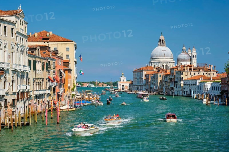 VENICE, ITALY, JULY 19, 2019: View of Venice Grand Canal with boats and Santa Maria della Salute church in the day from Ponte dell'Accademia bridge. Venice, Italy, Europe