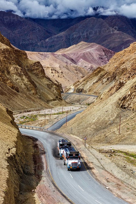 Indian lorry cistern fuel tanker trucks on NH-1 (Srinagar Leh national highway) in Himalayas. Ladakh, India, Asia