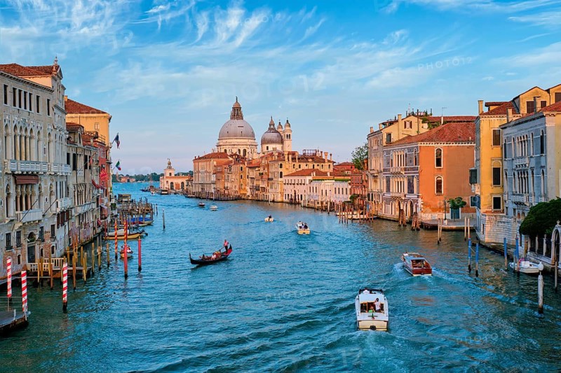 View of Venice Grand Canal with boats and Santa Maria della Salute church on sunset from Ponte dell'Accademia bridge. Venice, Italy, Europe