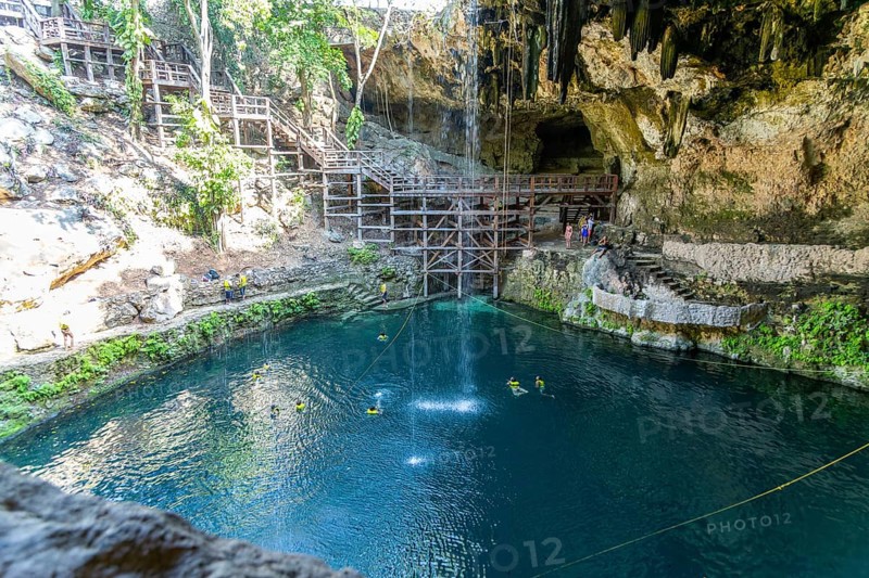 People swimming in Cenote Zaci carboniferous limestone swallow hole pool, Valladolid, Yucatan, Mexico, Central America