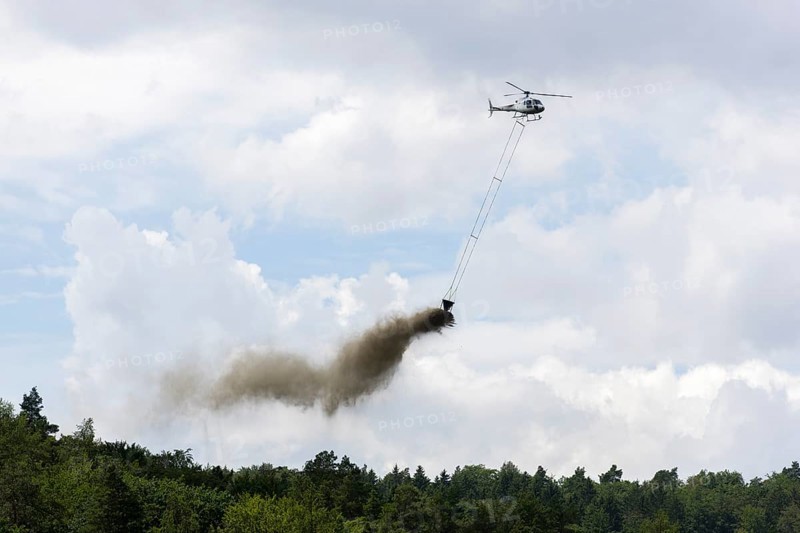 Symbolic image, climate change, helicopter, helicopter spreading finely painted limestone and wood ash against acid rain, mixed forest, container, soil protection liming, forest liming, Baden-Württemberg, Germany, Europe