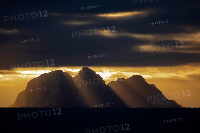 Island Værøy at the southern end of Lofoten under clouds with sunrays