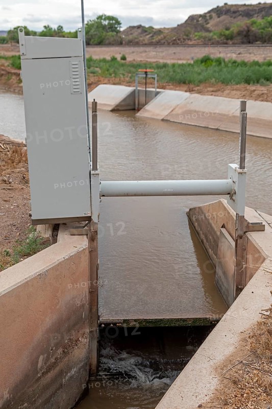 San Acacia, New Mexico, A gate on an irrigation canal allows water from the Rio Grande to be directed to a specific field. Much of the state is experiencing extreme drought, and farmers are not getting all the water they need to grow their crops in the desert