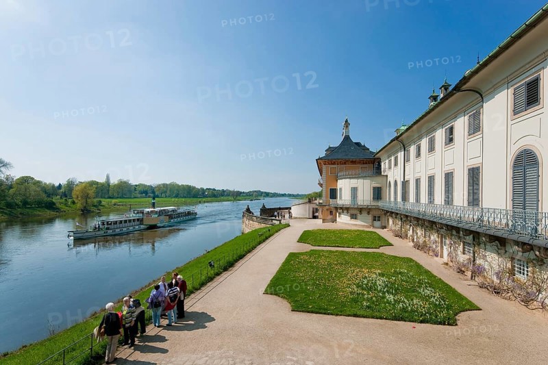 (© Sylvio Dittrich) (01772156417) Pillnitz, water palace with Elbe steamer. Pillnitz has become famous beyond the region for its palace and its park with the Pillnitz camellia. The park, which overlooks the banks of the Elbe and is surrounded by large green areas, is one of Dresden's tourist attractions