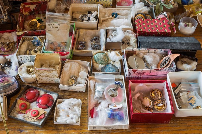 Earrings for sale displayed in boxes on table inside second hand goods and chattels store, Quebec, Canada, North America