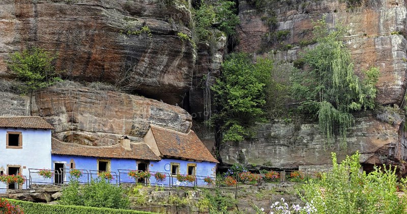 The blue troglodyte houses in rock face at Graufthal, Vosges, Alsace, France, Europe