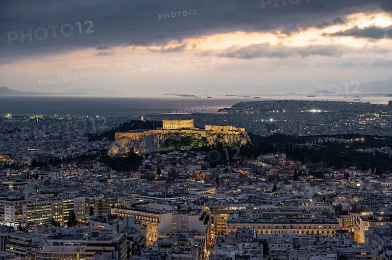 View over the sea of houses of Athens, illuminated Parthenon temple on the Acropolis, from Mount Lycabettus, Athens, Greece, Europe