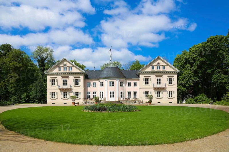Villa Eugenia, last residence of the Princes of Hohenzollern-Hechingen, classicist central building built from 1786 to 1787 by Prince Joseph Wilhelm as a summer pleasure garden house, side wings added from 1833 to 1834, residence for the then hereditary prince and later princely couple Friedrich Wilhelm Konstantin and Eugenie, meadow, park, garden, historic building, architecture, clouds, sky, flagpole, Hohenzollern coat of arms, Hechingen, Zollernalbkreis, Baden-Württemberg, Germany, Europe