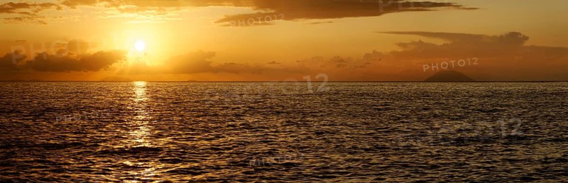 Sunset panorama on the beach of Tropea with the Aeolian (Liparic) Islands and the volcanic island of Stromboli on the horizon, Tropea, Vibo Valentia, Calabria, Southern Italy, Italy, Europe