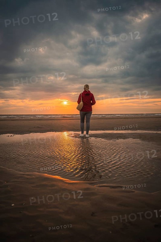 Tourist on the beach at sunset, Zandvoort, Netherlands
