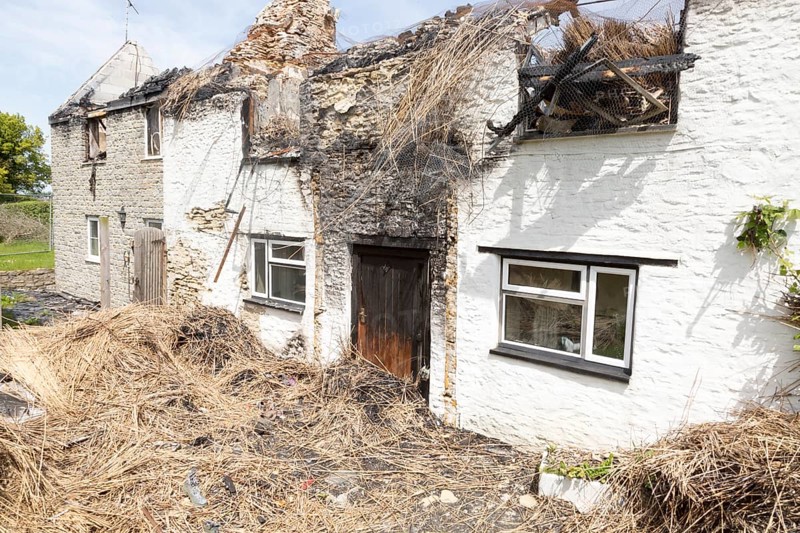 Country cottage homes burnt out destroyed by fire left in ruins, Redlynch, near Bruton, Somerset, England, UK