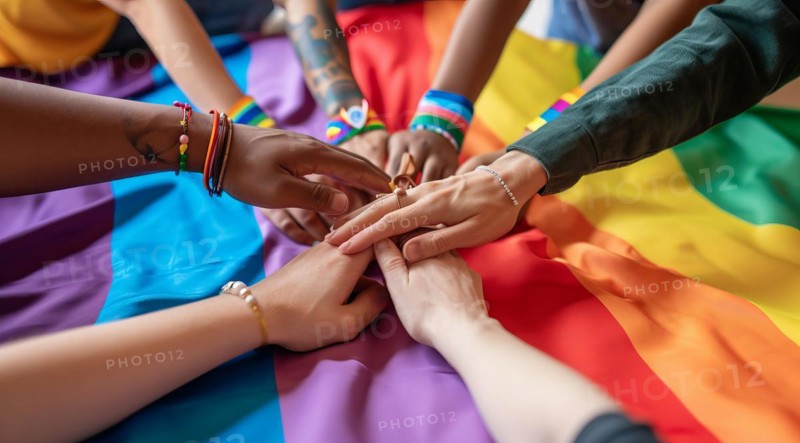Diverse people hands over rainbow LGBTQ flag showing love, affection and unity, AI generated