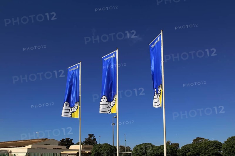 Company flags with logo Bibendum figure flying outside, Michelin factory and research establishment, Almeria, Spain, Europe
