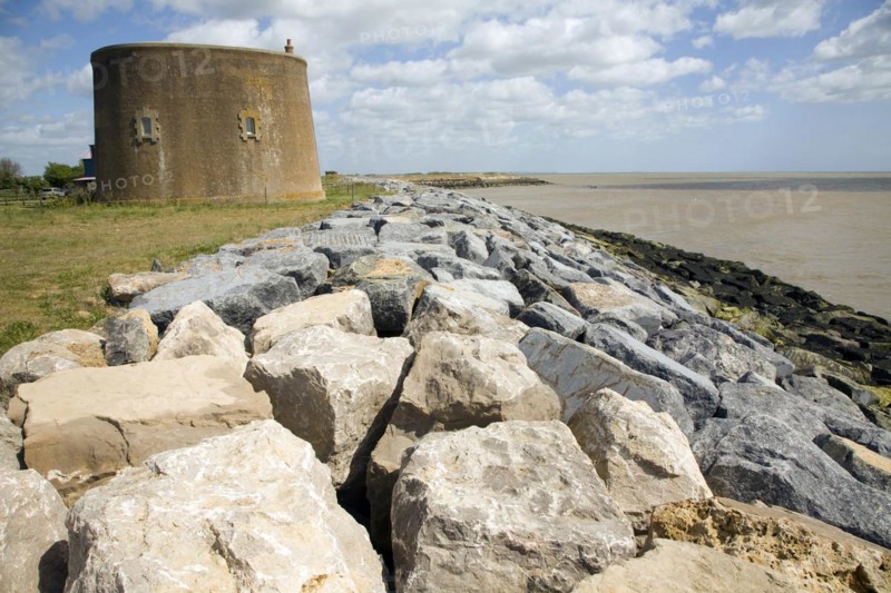 Rock armour coastal defences protect the martello tower East Lane, Bawdsey, Suffolk, England, United Kingdom, Europe