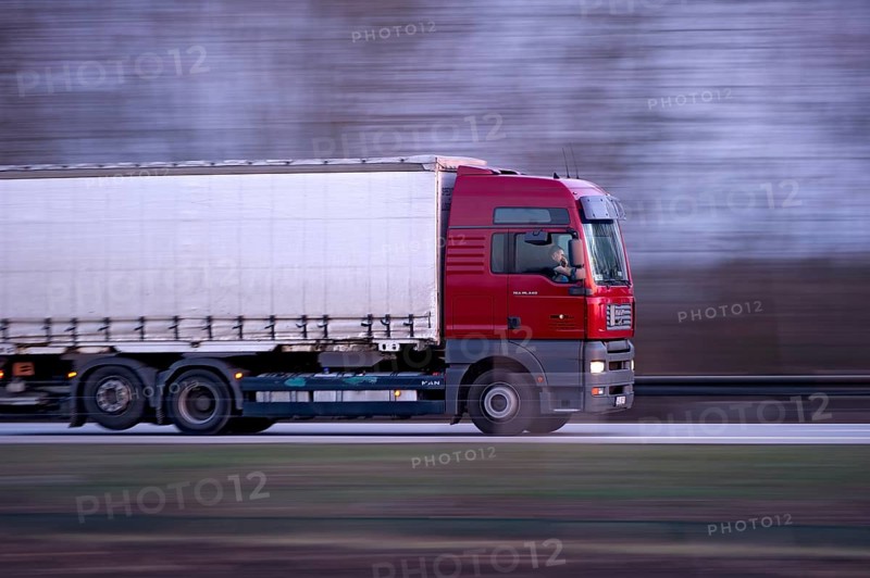 Unconcentrated driver in truck, lorry, semi-trailer MAN TGA 26.440 driving fast on the A92 motorway, motion blur, wiping effect, Freising, Upper Bavaria, Bavaria, Germany, Europe