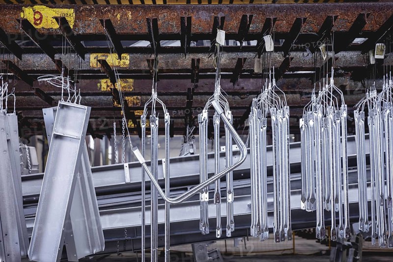Finished galvanised steel parts lie in the factory hall of a surface finishing factory of the Coatinc Company in Siegen, 22.08.2024