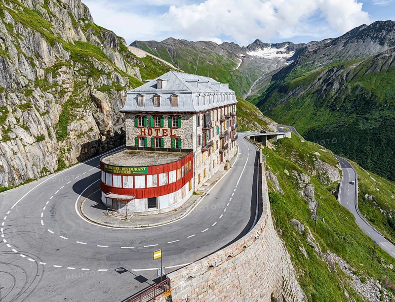Hotel Belvédère on the Furka, the most famous pass hotel in the world. The building is closed and falling into disrepair. A lost place. Rhone glacier. Drone photo. Obergoms, Canton Valais, Switzerland, Europe