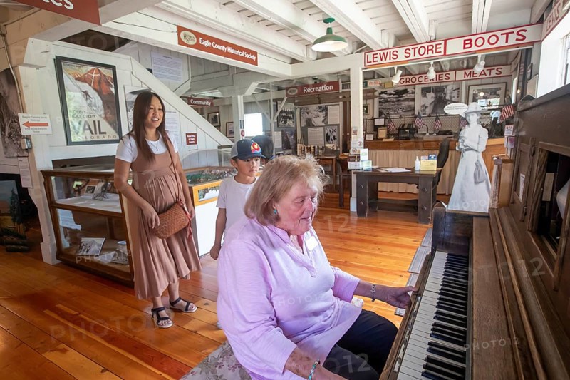 Eagle, Colorado, The Eagle County Historical Museum. A museum worker operates a player piano for visitors