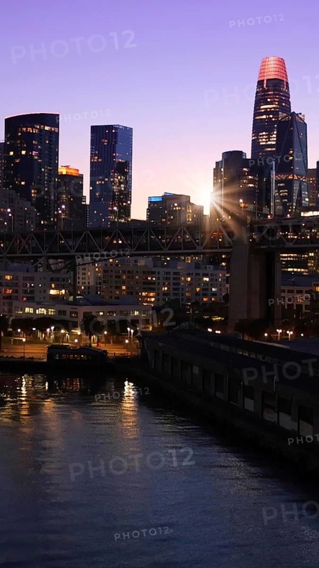 San Francisco Business Center panoramic city skyline view near Oakland Bay Bridge at sunset