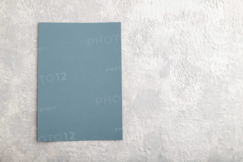 Blue paper business card, mockup on gray concrete background. Blank, flat lay, top view, still life, copy space