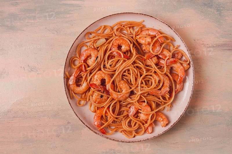 Spaghetti with king shrimps, with spices, top view, selective focus, homemade, no people