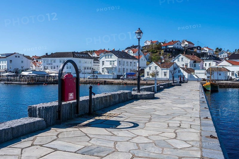 At the seaside in Risor, a traditional village with wooden white houses at the southern norwegian coast, Norway, Europe