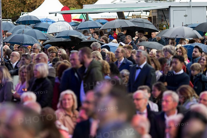 Guests stand under umbrellas at the Federal President's Citizens' Festival in Bellevue Palace Gardens, Berlin, 13/09/2024
