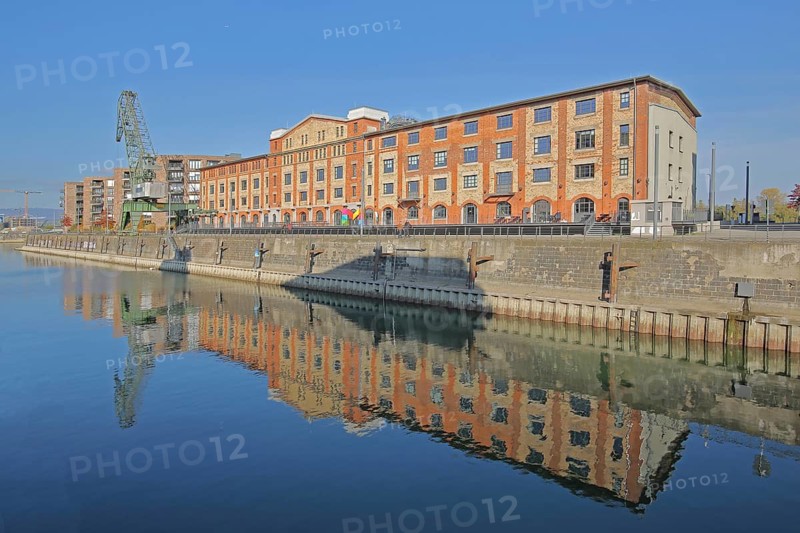 Old wine warehouse with harbour crane, quay and reflection, quay wall, harbour, gantry crane, container crane, shipyard crane, cargo crane, customs harbour, Neustadt, Mainz, Rhine-Hesse region, Rhineland-Palatinate, Germany, Europe