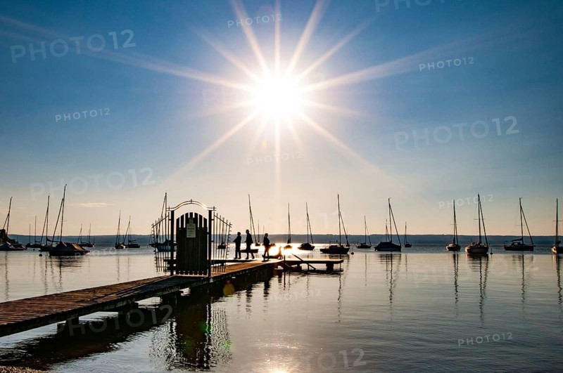 Jetty on the Lake Ammer backlit, Bavaria, Germany, Europe