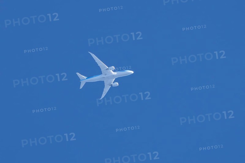 Boeing 787-8 Dreamliner jet aircraft of TUI airlines flying in a blue sky, England, United Kingdom, Europe