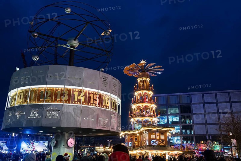 A Christmas pyramid behind the World Time Clock at the Christmas market on Alexanderplatz, Berlin, 21.12.2024