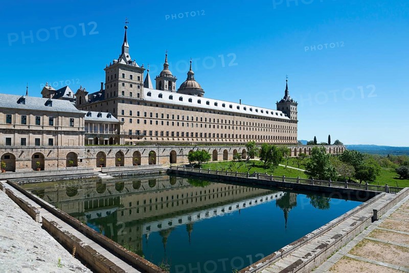 Historic monastery with reflection in the water trough under a blue sky, Real Sitio de San Lorenzo de El Escorial, Royal Seat of St Lawrence of El Escorial, palace and monastery complex, San Lorenzo de El Escorial, Madrid, Spain, UNESCO World Heritage Site, Europe