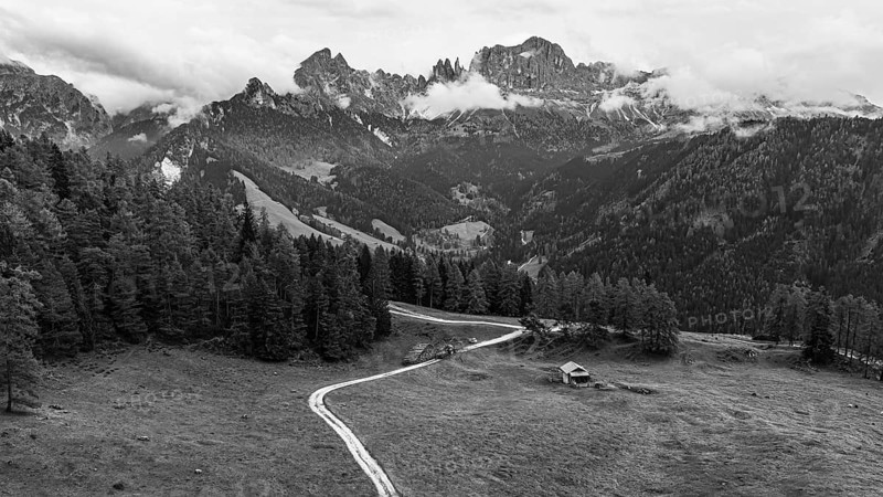 Alpine meadow Wuhnleger, behind the peaks of the rose garden, shrouded in fog, drone shot, black and white, Dolomites, Autonomous Province of Bolzano, South Tyrol, Italy, Europe