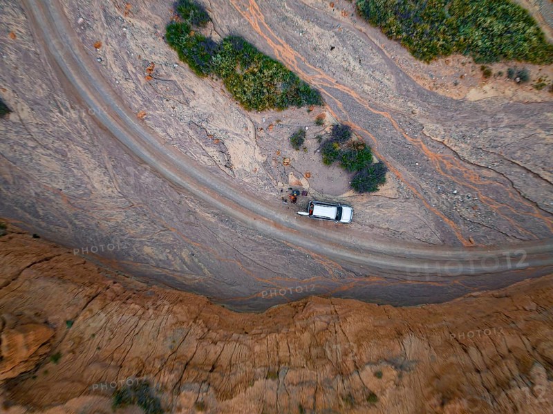 Off-road vehicle on a track in a riverbed, landscape of eroded hills, top-down, badlands, aerial view, Canyon of the Forgotten Rivers, Issyk Kul, Kyrgyzstan, Asia