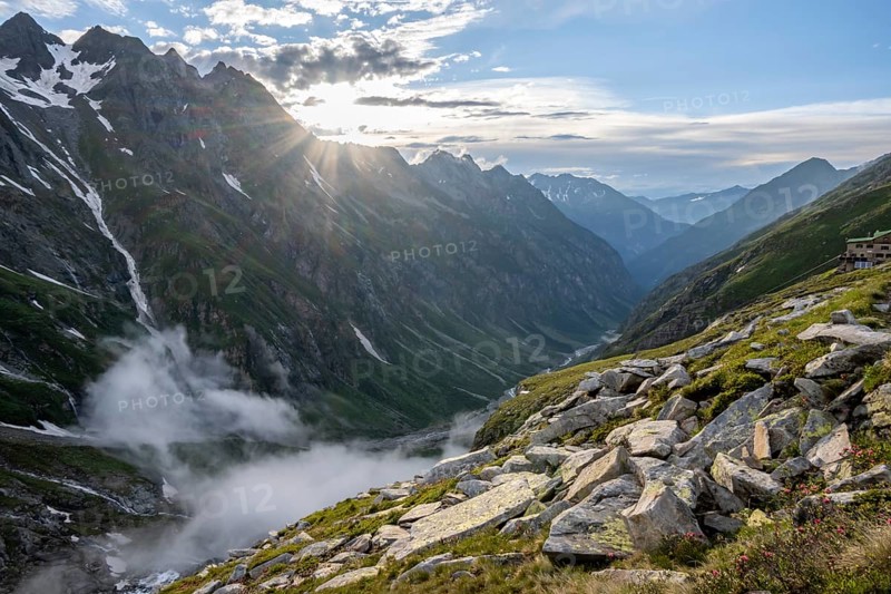 Atmospheric mountain landscape, clouds forming in a mountain valley in the evening light, sun star, Floitengrund valley, Greizer Hütte, Berliner Höhenweg, Zillertal Alps, Tyrol, Austria, Europe