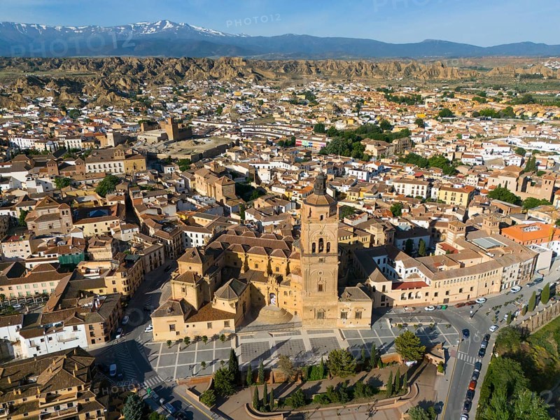 Large church and various buildings in an extensive urban landscape surrounded by mountains. Clear sky and sunny, aerial view, Cathedral, Catedral de la Encarnación de Guadix, Guadix, Sierra Nevada, Granada, Andalucia, Spain, Europe