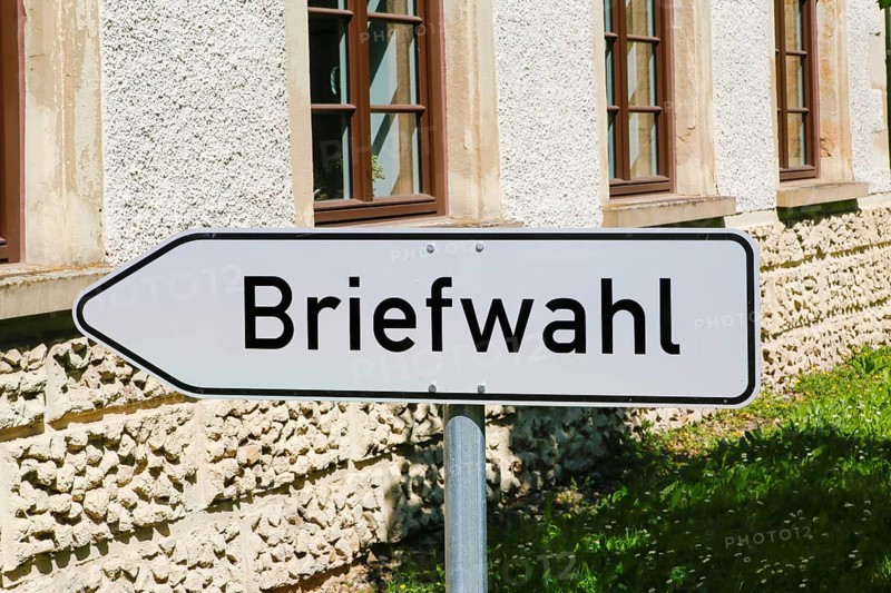 Postal voting sign, signpost for postal voting, writing, letters, information board, behind Varbülersches Schloss, Schloss Hemmingen, former seat of the barons of Varnbüler, main building today town hall, Hemmingen, Ludwigsburg district, Baden-Württemberg, Germany, Europe