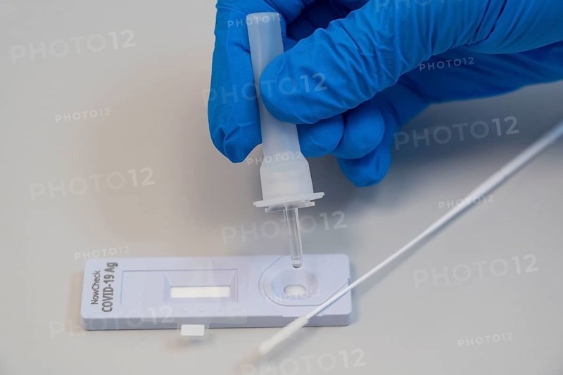 Covid-19 rapid test, antigen test, the abrasion of the swab is dissolved in a liquid and applied to the test device, after a few minutes the test device shows the result by a black line whether the person has tested positive or negative