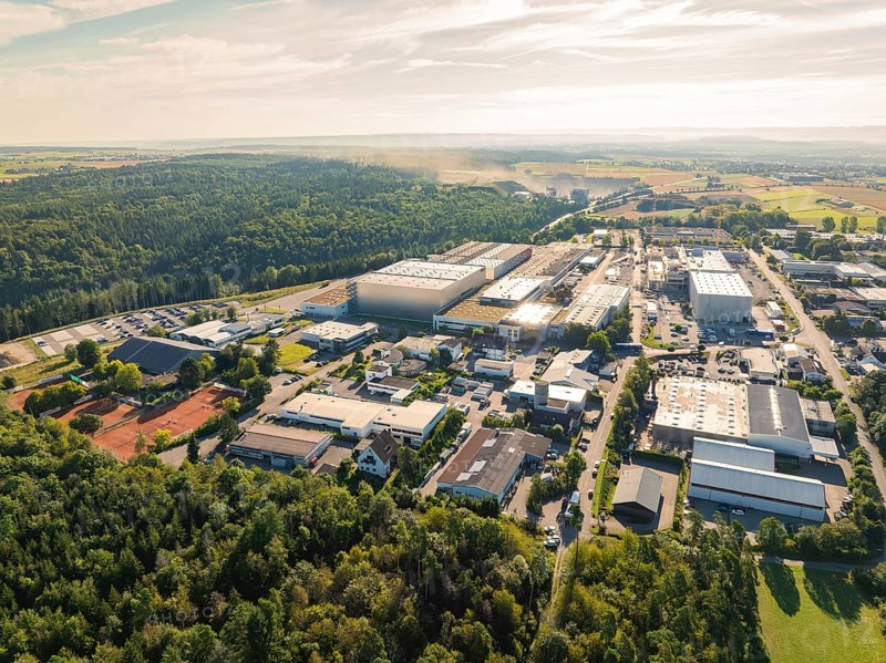 Industrial area surrounded by forest and landscape, numerous buildings and streets under a clear sky, Industrial area Wolfsberg, Nagold, Black Forest, Germany, Europe