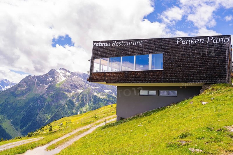 A modern restaurant on a mountain with a view of the surrounding mountains and meadows under a cloudy sky, Penken, Zillertal, Austria, Europe