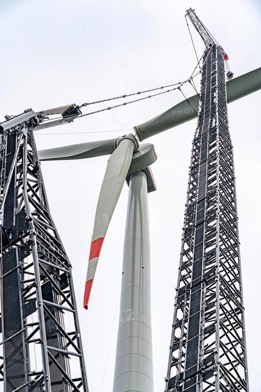 Erection of a wind turbine, wind energy plant, assembly of the third blade, with a crawler lattice crane, wind farm near Hagen, North Rhine-Westphalia, Germany, Europe