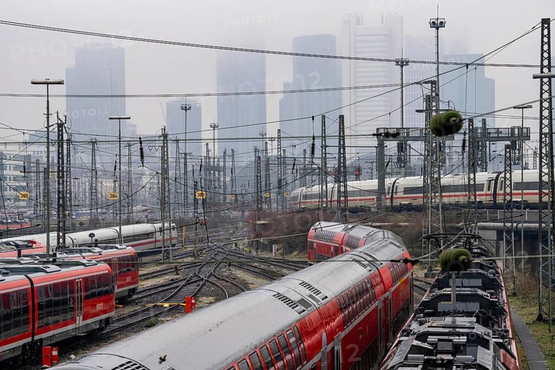 Railway tracks with regional and long-distance trains, ICE, after freezing rain, in front of Frankfurt main station, skyline in the fog, Hesse, Germany, Europe