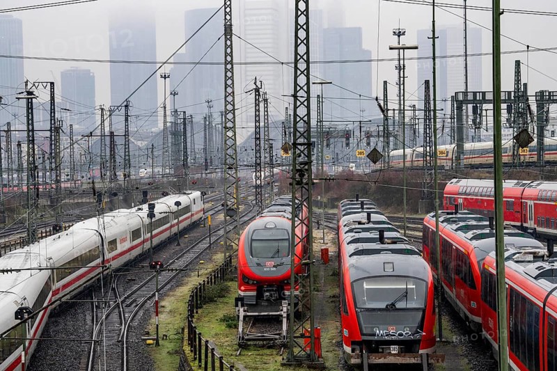 Railway tracks with regional and long-distance trains, ICE, after freezing rain, in front of Frankfurt main station, skyline in the fog, Hesse, Germany, Europe