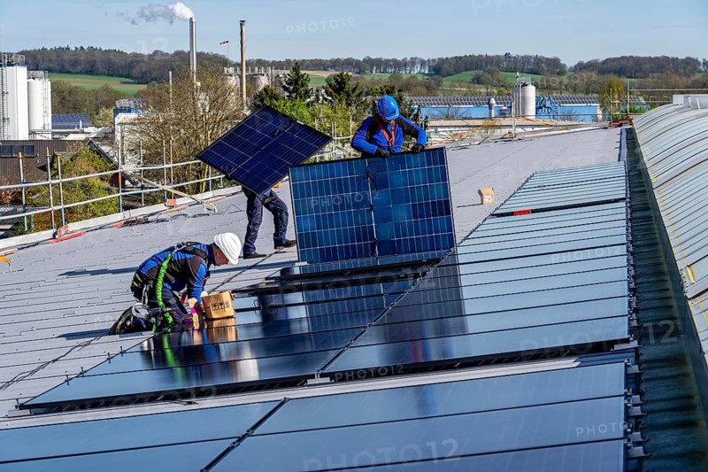 Installation of solar modules on the roof of a commercial enterprise, over 400 photovoltaic modules are installed on the roof, North Rhine-Westphalia, Germany, Europe