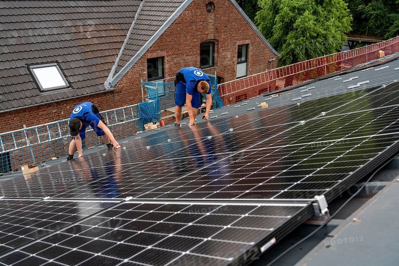 Installation of solar modules on the roof of a barn on a farm, over 240 photovoltaic modules are installed on the roof, North Rhine-Westphalia, Germany, Europe